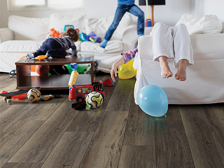 kids playing in room with wood-look laminate flooring from Perge Carpet & Floors in Wheaton, MD